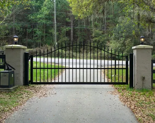 automatic double swing driveway gate at residential property entrance