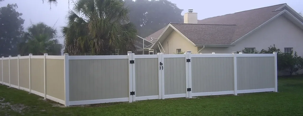 White vinyl privacy fence installed along the front of a residential home in Florida