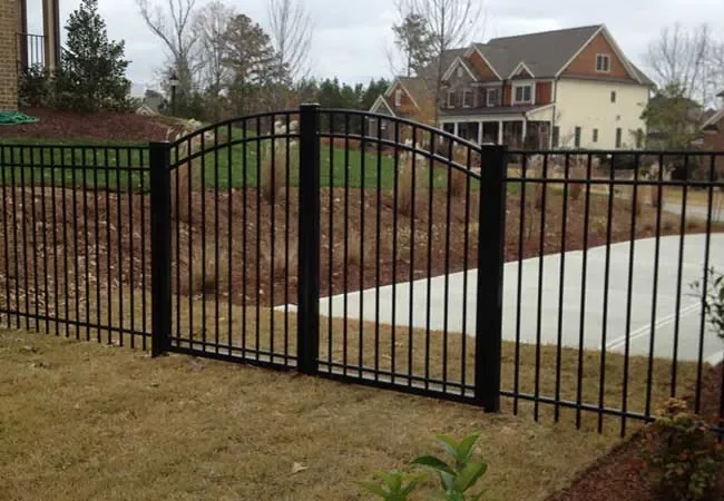 Black aluminum fence installed along residential driveway in Florida