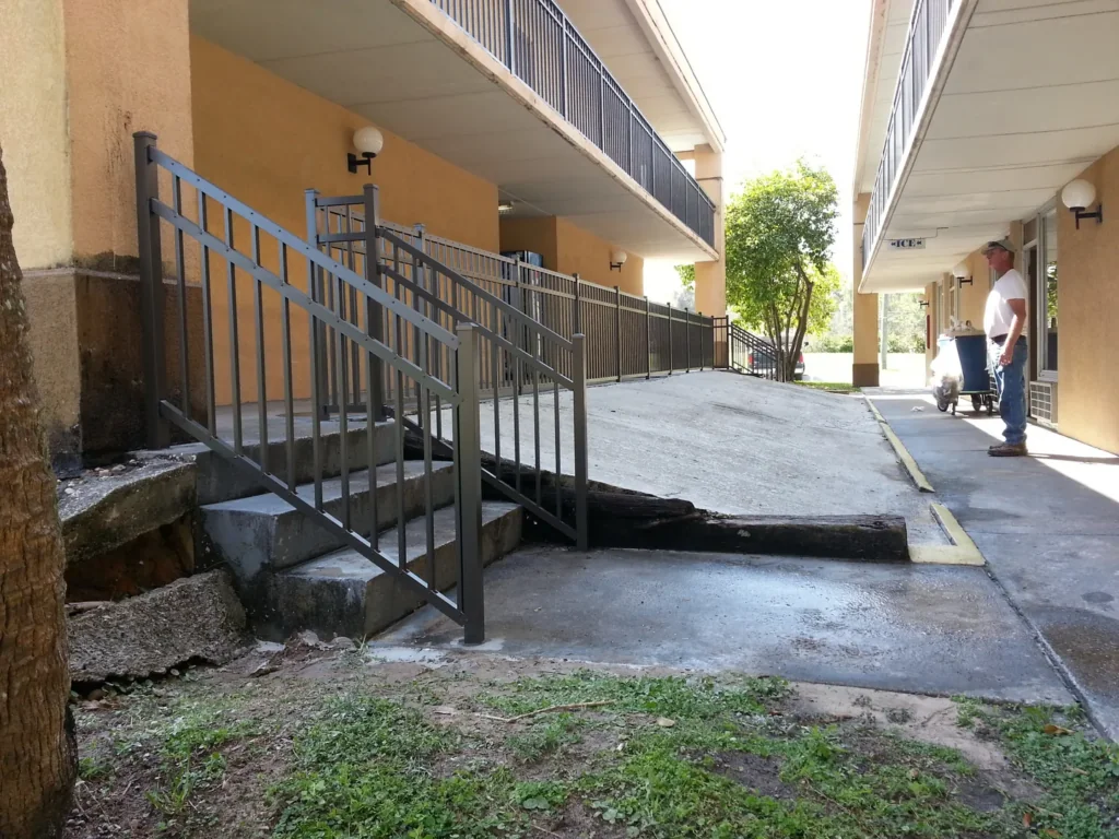 Black aluminum railing installed along commercial ramp and stairs in Florida