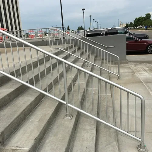 Standard aluminum handrail installed on commercial concrete stairs in Florida